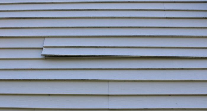 A,Loose,Piece,Of,Vinyl,Siding,On,A,House | Hatch Homes