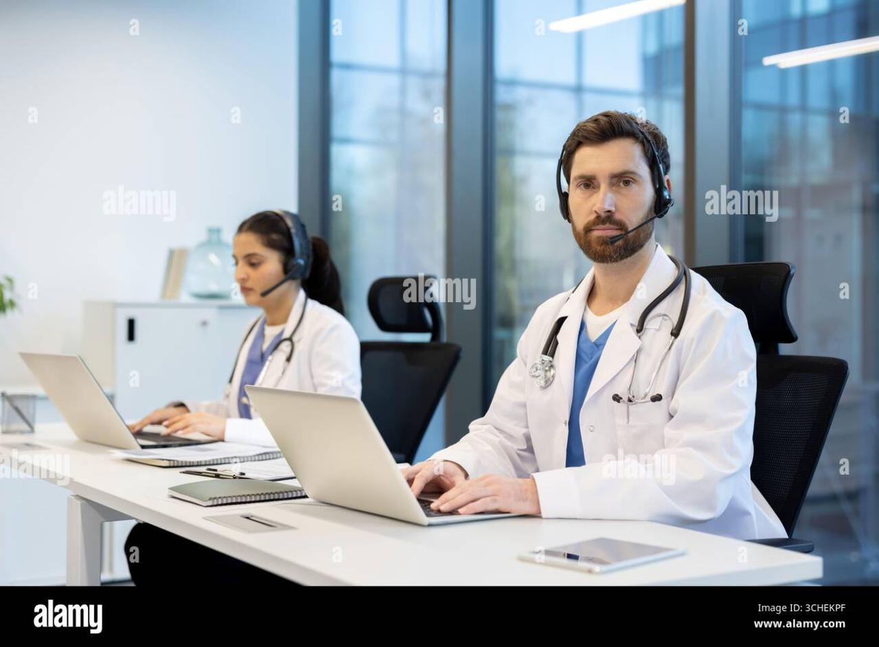 Two doctors collaborating with headsets and laptops in a modern clinic ...